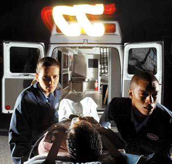 Photo of paramedics loading patient into ambulance