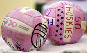 A photo of pink "Go Huskies" volleyballs