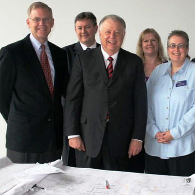 NIU President John G. Peters looks over construction plans with officials from Illinois Valley Community College.
