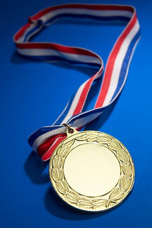 Photo of a medal on a red, white and blue ribon