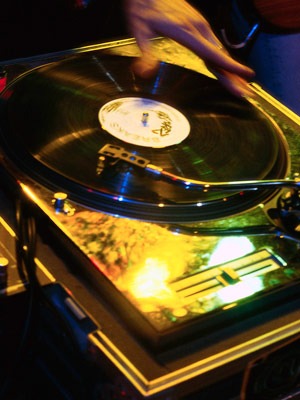 Photo of DJ spinning record on turntable