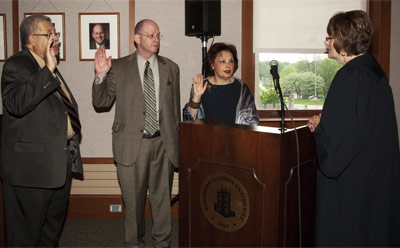 The Honorable Judge Robbin Stuckert administers the oath of office Thursday, May 12, to new NIU Trustee Robert T. Marshall (left) and returning trustees Marc J. Strauss and Cherilyn G. Murer.