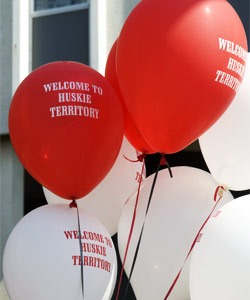 Photo of red and white "Welcome to Huskie Territory" balloons