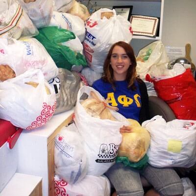 NIU student Megan Maloney sits with plastic bags collected to weave sleeping mats for Chicago's homeless.