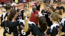 Photo of volleyball team huddle