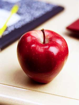 Photo of an apple on a teacher’s desk