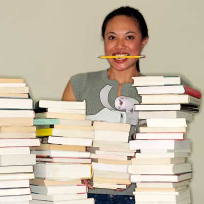 Photo of a woman behind stacks of books