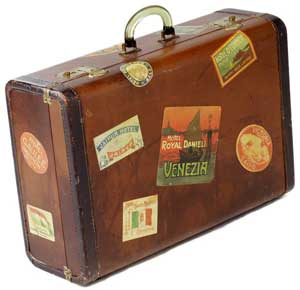 Photo of a suitcase with international travel stickers
