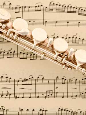 Photo of a flute placed on sheet music