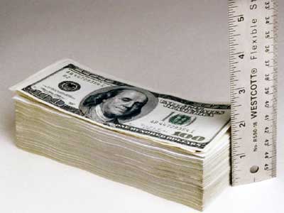 Stack of money next to ruler