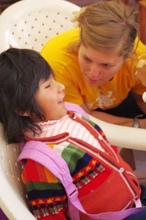 NIU alumna Molly Clesen teaches a song to a 4-year-old visually impaired child in Bolivia.