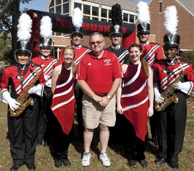 Steve Kalber (center) with members of the marching band at Homecoming.