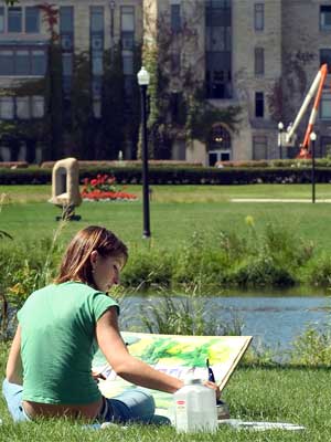 An NIU student paints at the East Lagoon.