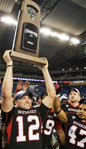 Quarterback Chandler Harnish displays the championship trophy to the happy Huskie Nation.