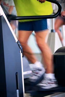 Photo of adult exercising on a elliptical machine.
