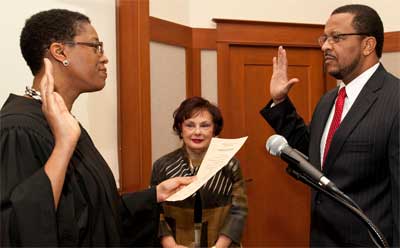 The Hon. Sharon J. Coleman, a federal judge for the Northern District of Illinois, administers the oath of office to her husband, Wheeler G. Coleman.