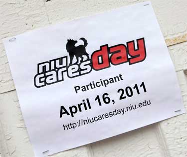 Photo of an NIU Cares Day 2011 sign stapled to wall