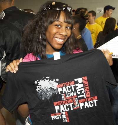 Photo of an NIU student with a Northern PACT T-shirt