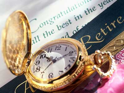 Photo of gold pocket watch and retirement greeting card