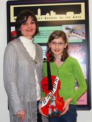 Somonauk artist Anna Kennedy and her daughter, Sophie, show the painted violin created for Performathon.