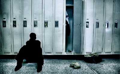 Image of silhouetted youth in front of a row of lockers