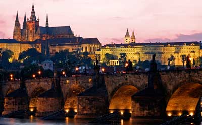 A photo of the Charles Bridge in Prague at sunset.
