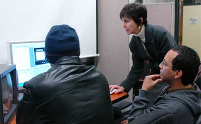 Laura Vaquez works with students in the editing suite.
