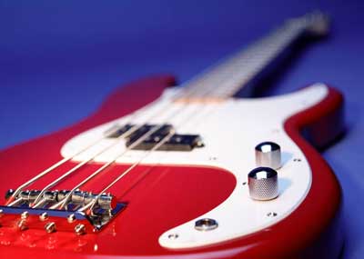Photo of a red-and-white electric bass guitar