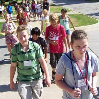 Summer campers walk north on Normal Road.