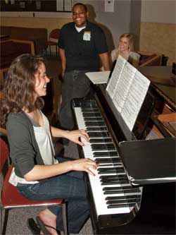 NIU Honors students relax around the piano.
