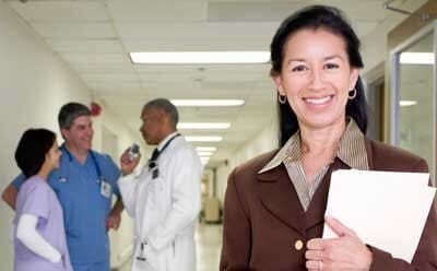 Stock image of a public health worker in a hospital hallway