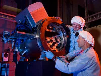 This Fermilab image shows scientists building a prototype of the Dark Energy Camera, which will survey about one-tenth of the sky to measure 300 million galaxies and discover thousands of supernovae.