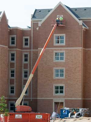 Workers are busy completing NIU’s new residential complex, which opens this fall.