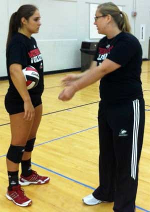 Assistant coach Lynnette Moster works with freshman Alexis Gonzales.