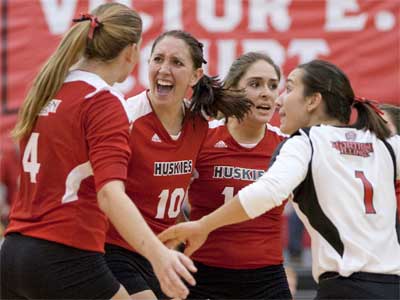 From left: Meghan Romo, Mary Kurisch, Alexis “Pookie” Gonzalez and Justine Schepler celebrate a Huskie volleyball victory.