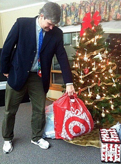 Communication professor David Henningsen drops off gifts for foster children at the Lutheran Child and Family Services office in Belvidere.