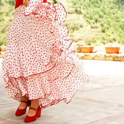 Photo of the flowing skirt and shoes of a flamenco dancer