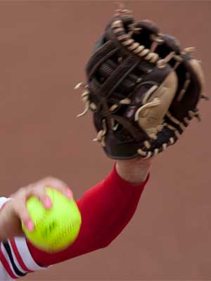 Photo of a NIU softball pitcher's arm and hand with ball and glove