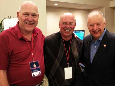 Former NIU football coaches Joe Novak and Jerry Kill visit with President John Peters in Miami.