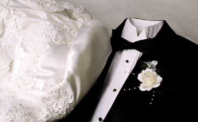 Photo of a bridal gown and tuxedo