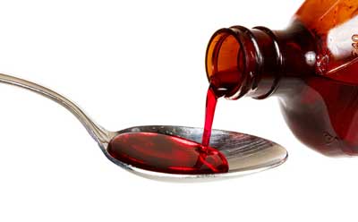 Photo of cough syrup being poured into a spoon