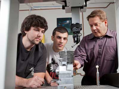 NIU Department of Technology professor David Schroeder works with students.