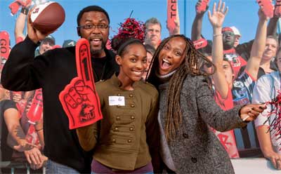 Students and their families can pose with a photograph of other  NIU Huskie football fans during Admitted Student Days, like this one in Decmeber of 2012.