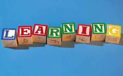 The word “learning” spelled in alphabet blocks