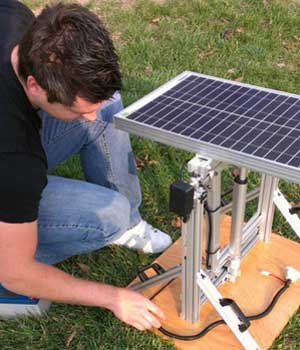 Photo of a student and a solar panel