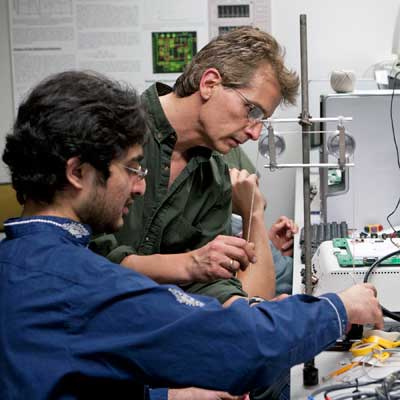 Photo of a student and professor working in a science lab