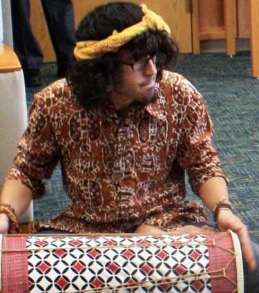 A member of the NIU Gamelan Ensemble helps to break the “quiet” rule inside the Rare Books Room of Founders Memorial Library.