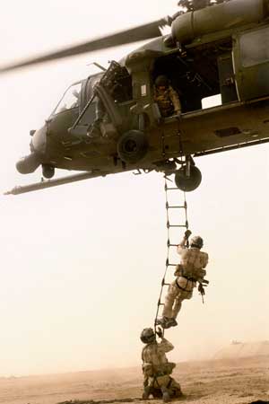 Photo of troops climbing the ladder to a helicopter