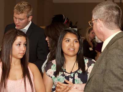Students talk to Michael Day, director of the First Year Composition Program, at a previous Showcase of Student Writing.