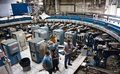 Physicists stand inside the Muon g-2 storage ring, in its current location at Brookhaven National Laboratory in New York. (Credit: Brookhaven National Laboratory)